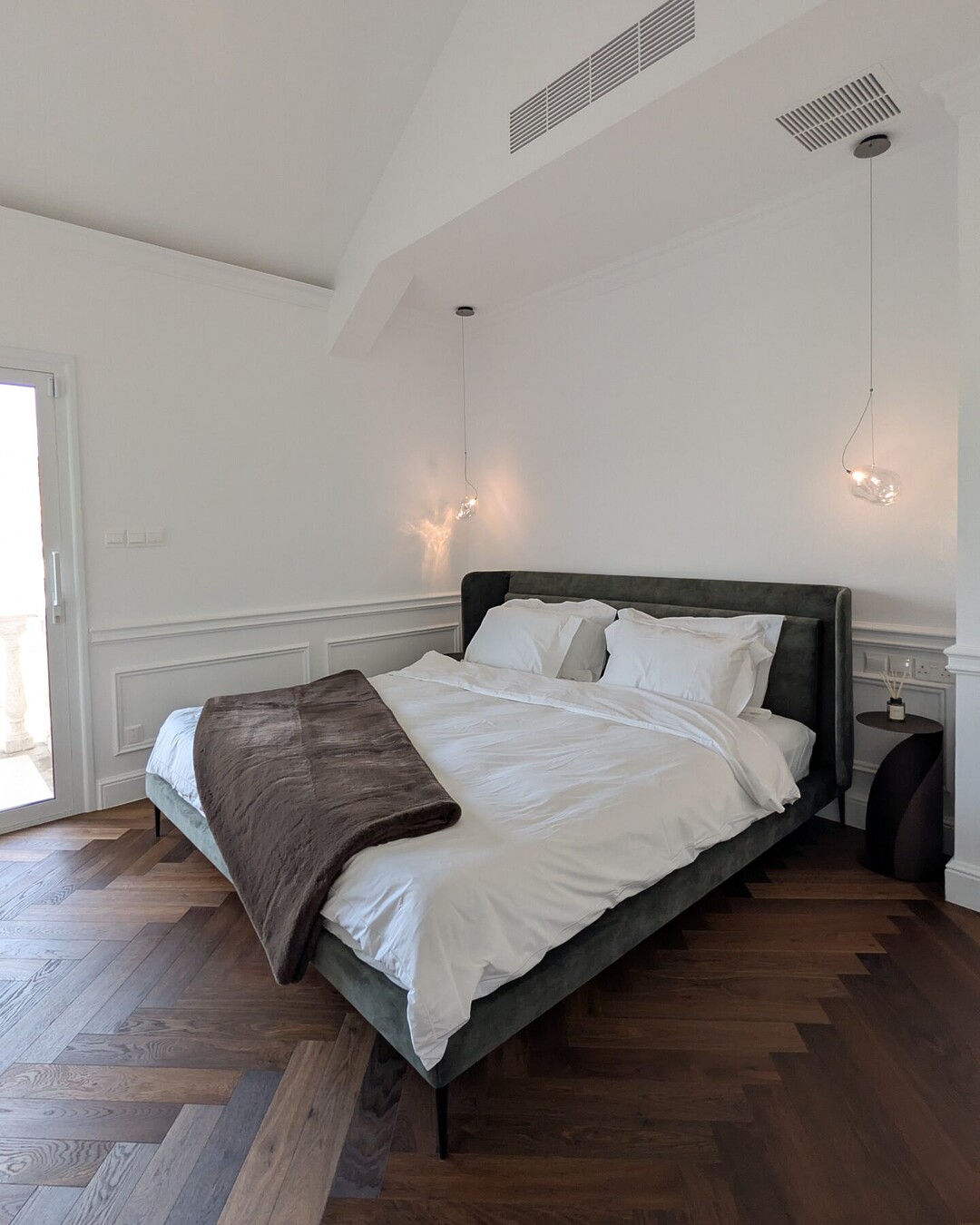 Bedroom with vaulted ceiling and panelled walls