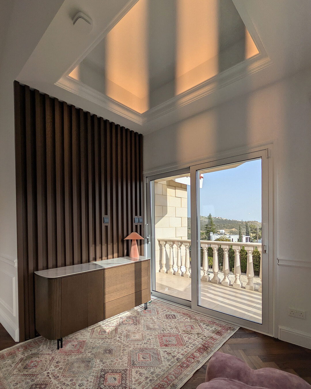 Slatted timber feature wall under a lit ceiling